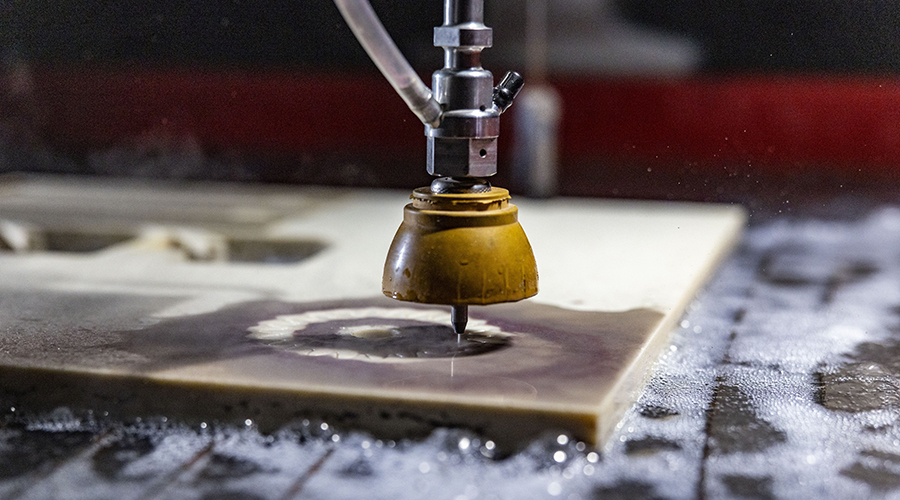 Swift-Jet Pro CNC cutting table close up of head cutting out of stone